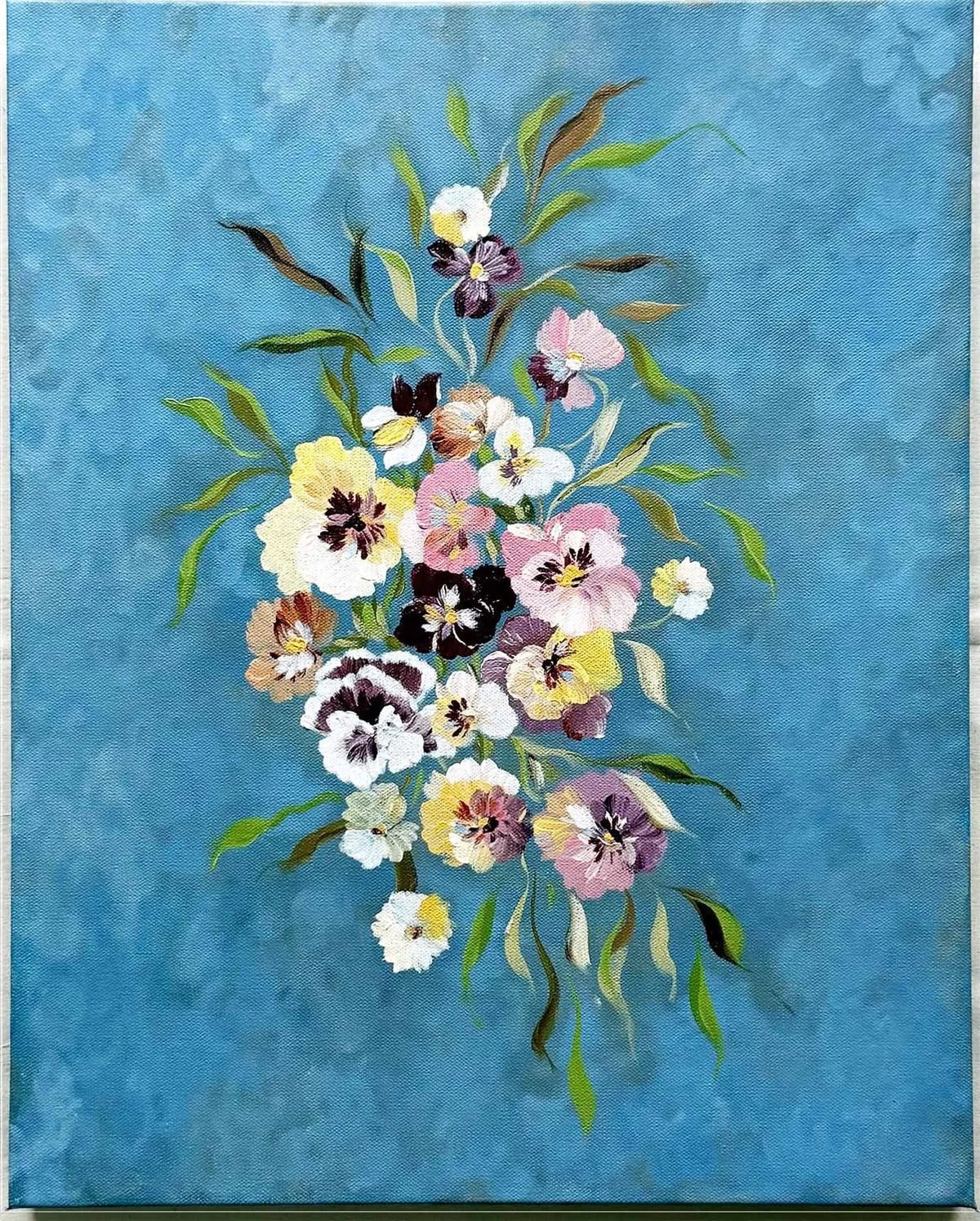 A textured Original sky blue canvas painting featuring a central bouquet of pansies and iris flowers in soft pink, yellow, white, and purple tones with green leaves.