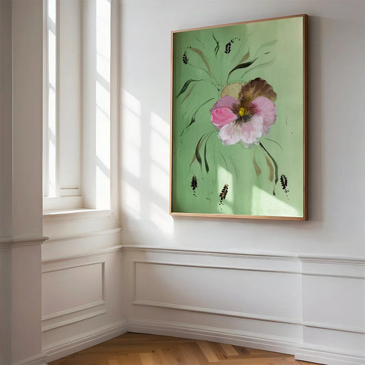 Large pink pansy print on green hanging beside a sunlit window.