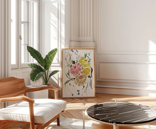 Ranunculus bouquet print leaning in a bright living room beside a potted plant and wooden chair.