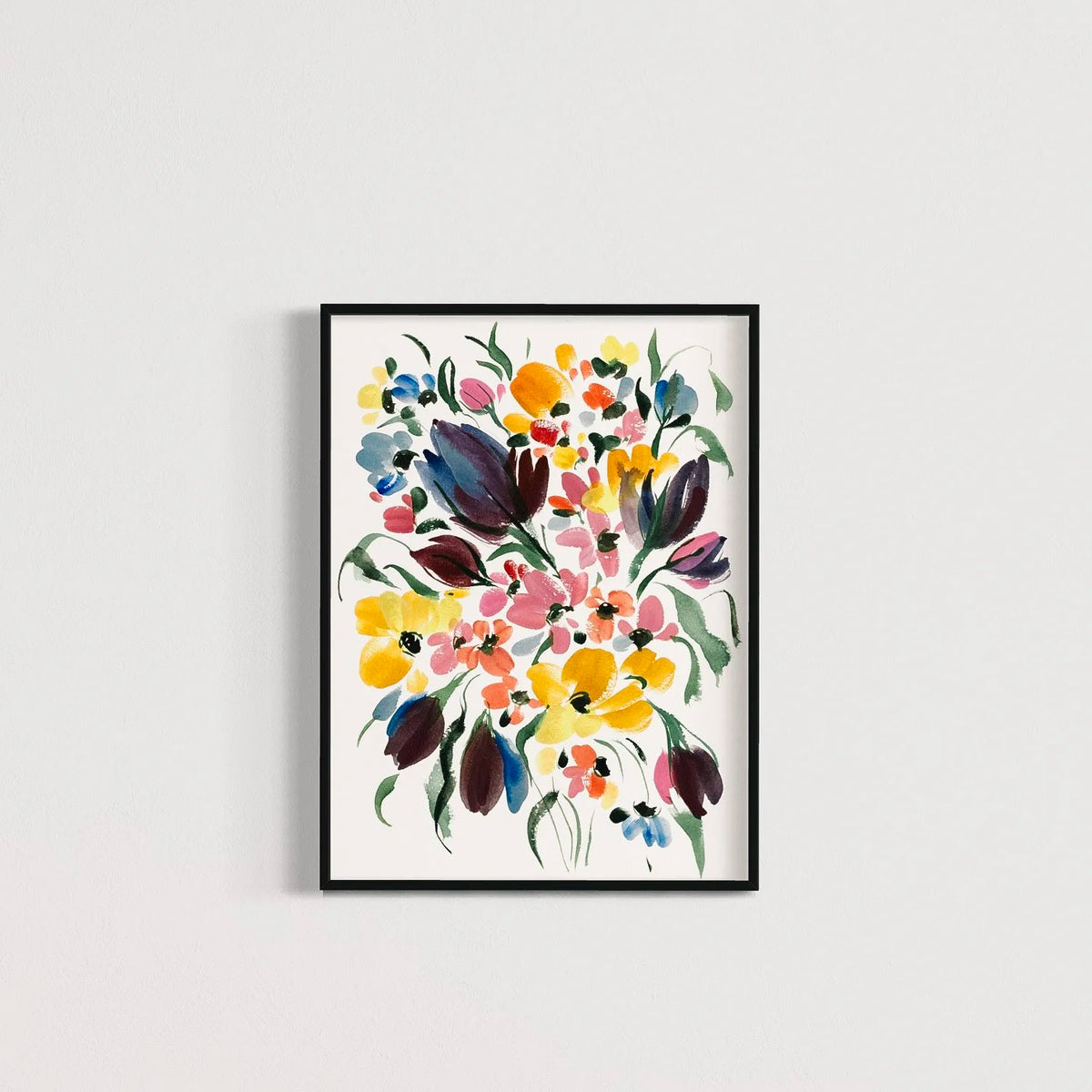 Dark purple tulip and colorful floral print in a black frame on a pale wall.