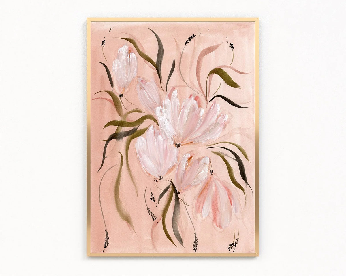 A framed floral painting featuring soft pink tulips with green and dark accents on a dusty pink background, enclosed in a light wood frame and displayed against a white wall.