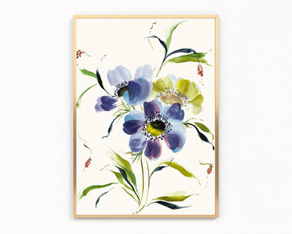 Gold-framed print of blue and purple anemones with a yellow bloom and green leaves on ivory.