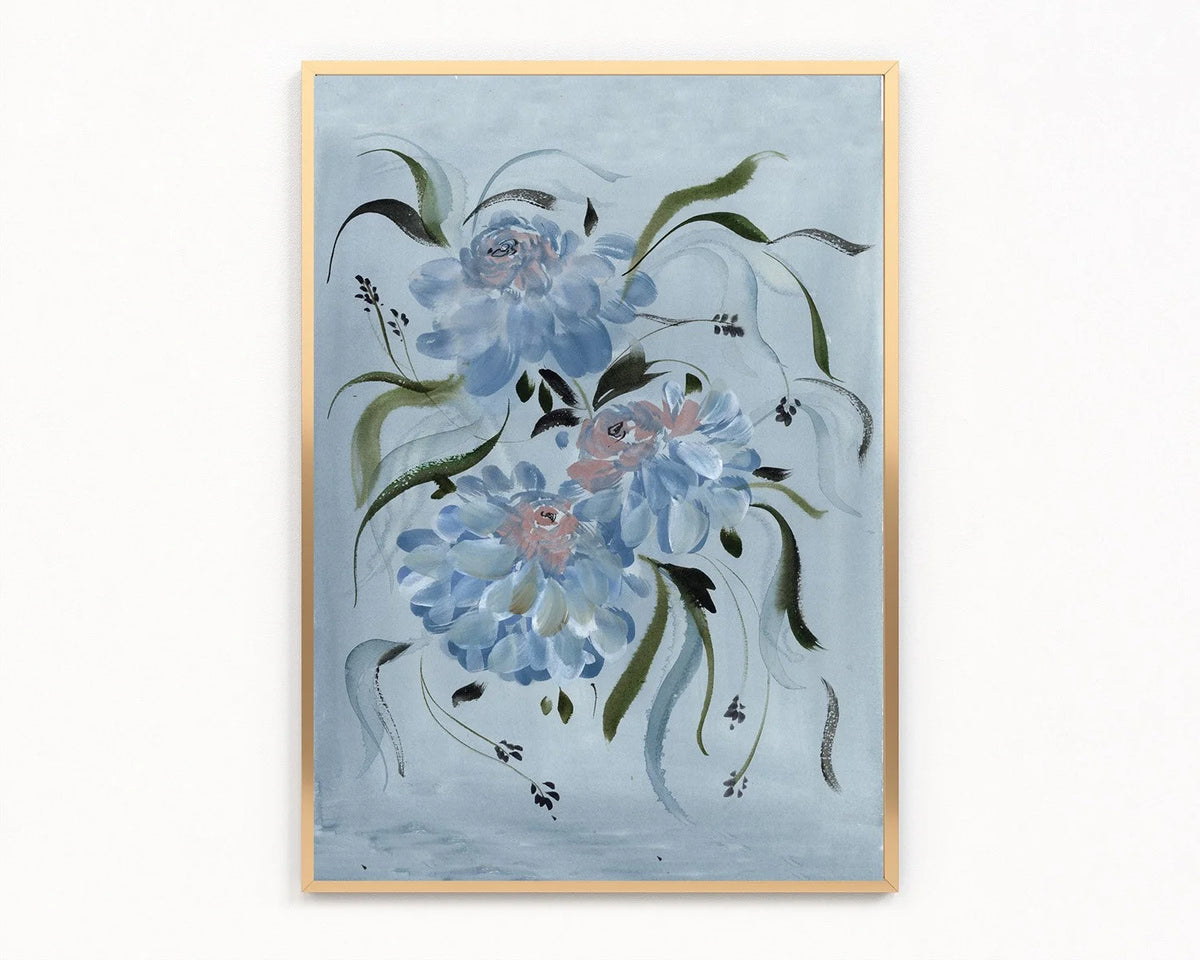 Gold-framed print of blue ranunculus and flowing green leaves on a pale blue background.
