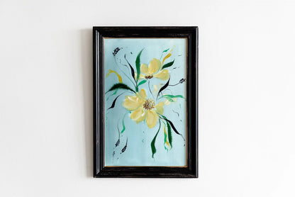 Yellow wildflower print on pale blue in a black frame.
