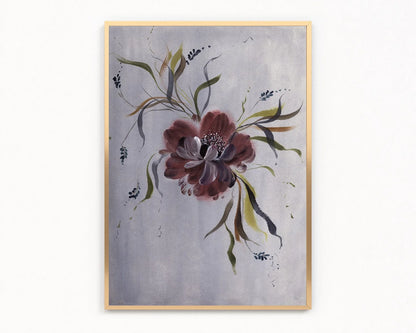 Gold-framed print of a burgundy anemone with flowing green leaves on lavender-gray.