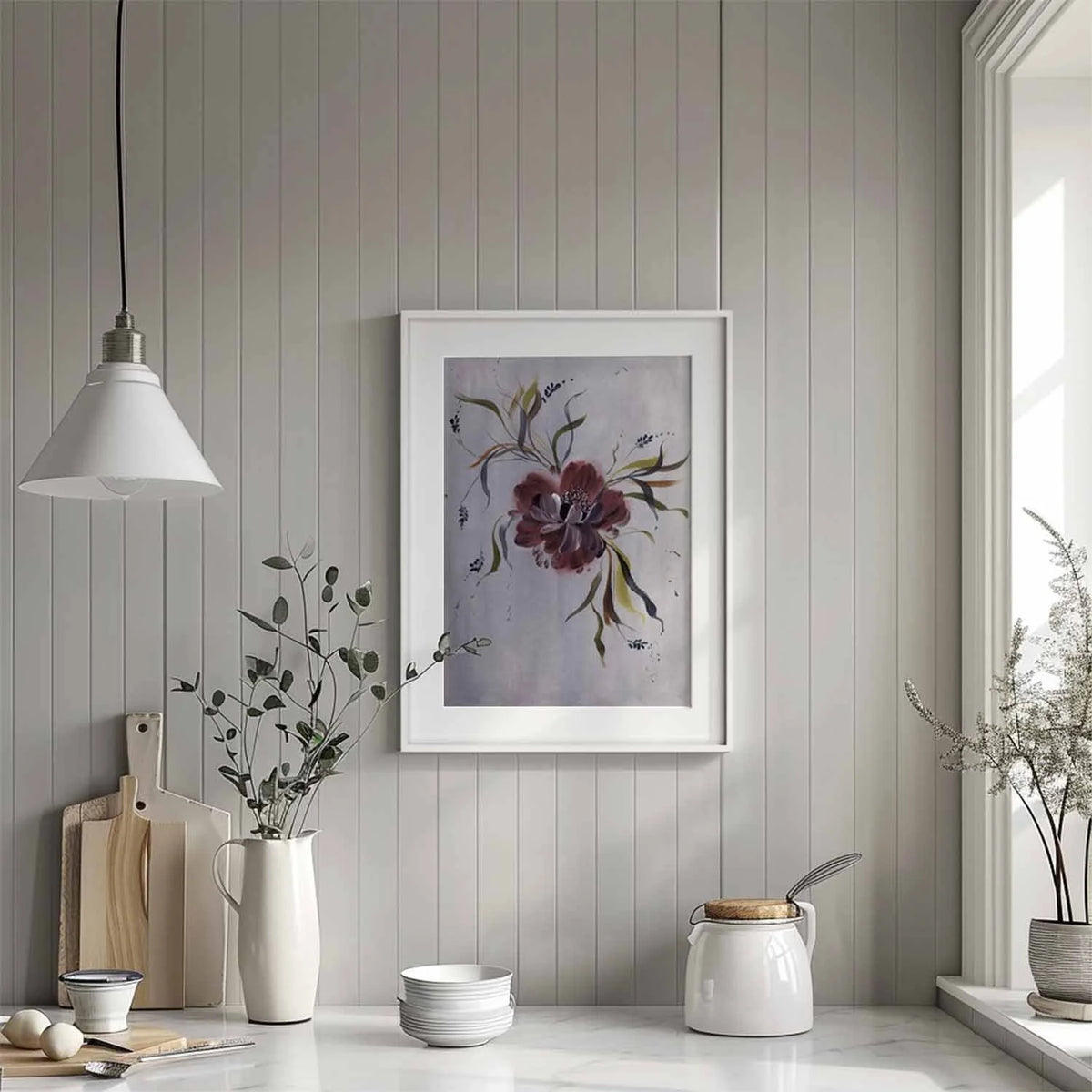 Burgundy anemone print in a white matted frame above a kitchen counter.