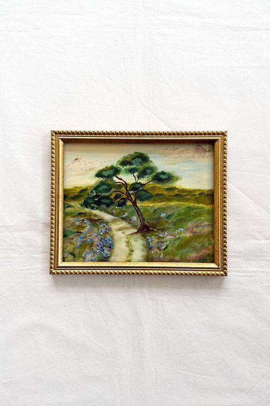 Original Landscape by ramya rajiv in a gold frame, the pastoral landscape shows a single tree along the path.