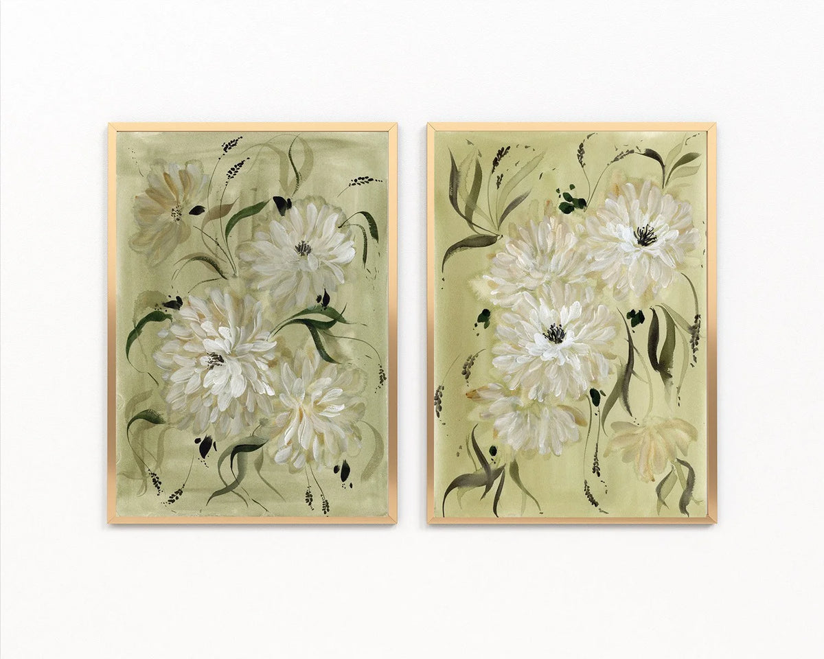 Two gold-framed prints of white dahlias and slender green leaves on sage backgrounds.