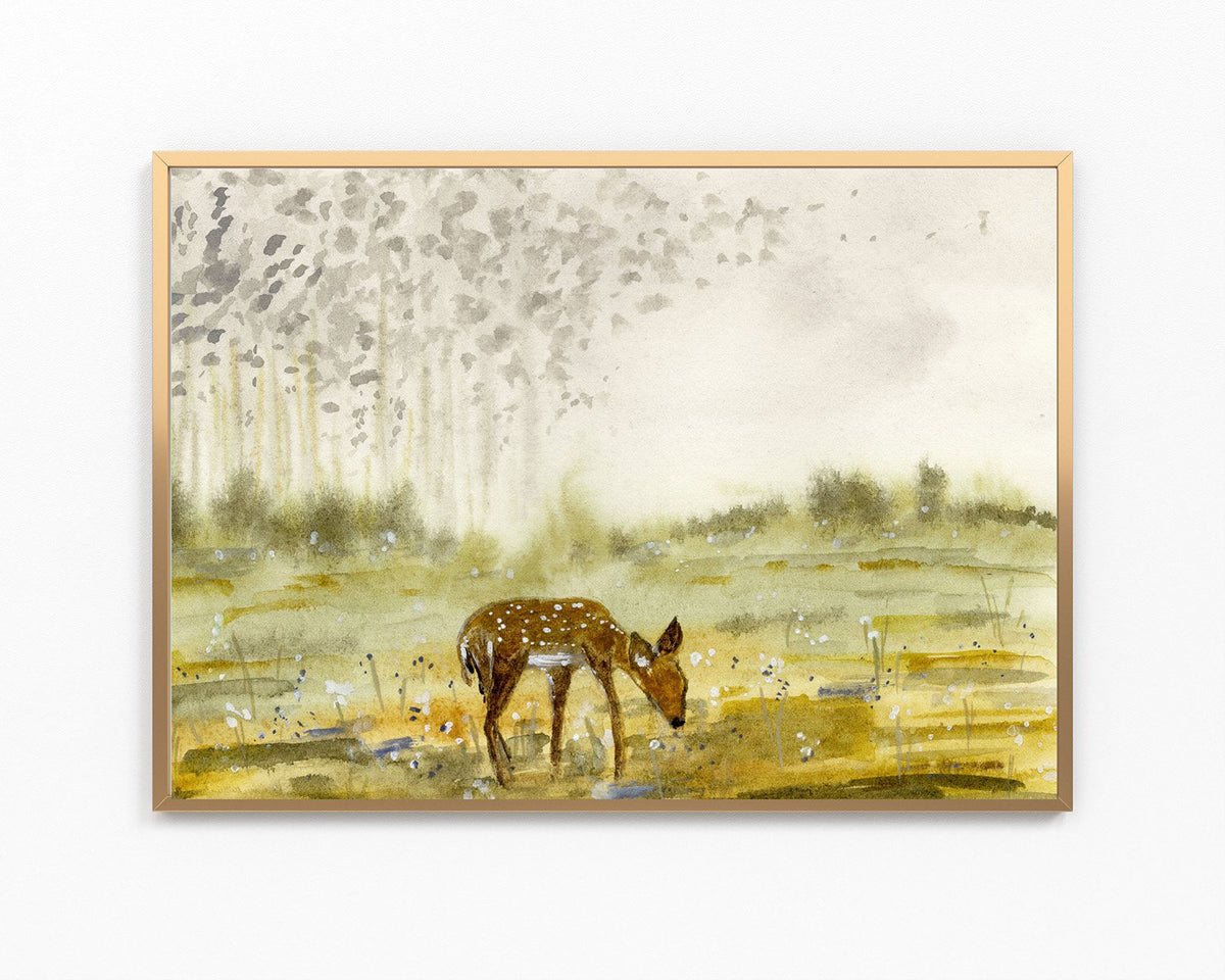 A framed watercolor painting of a brown spotted deer standing in a golden field under a misty, light-colored sky