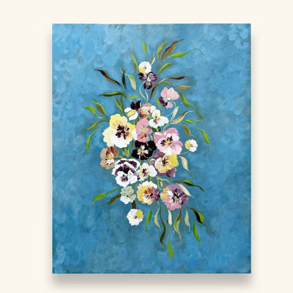 A canvas painting featuring a vibrant bouquet of pansies on a textured sky blue background. Original art by Ramya Rajiv