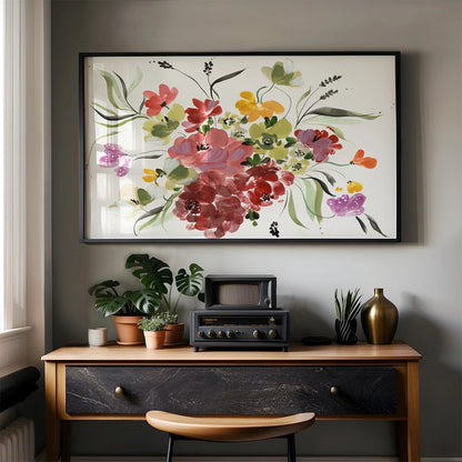 Large horizontal floral print in a black frame above a desk with plants and vintage audio equipment.