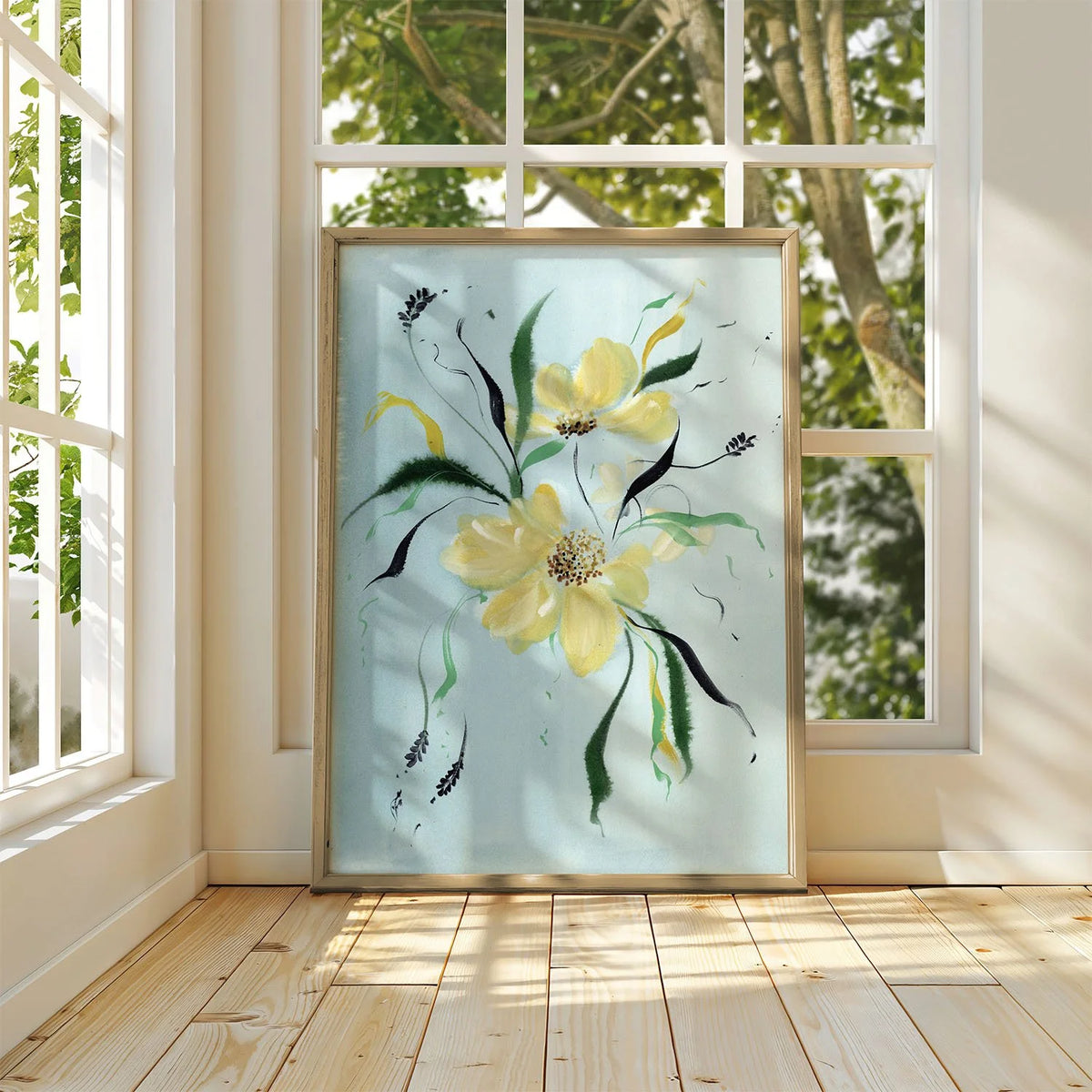 Large yellow wildflower print on blue leaning against a sunlit window.