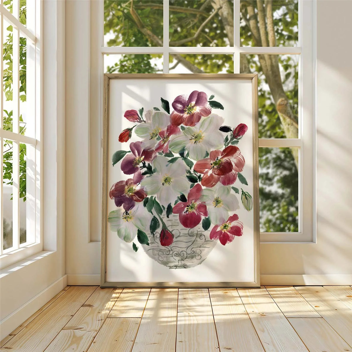 Framed burgundy and white hellebore bouquet print leaning against a sunlit window.