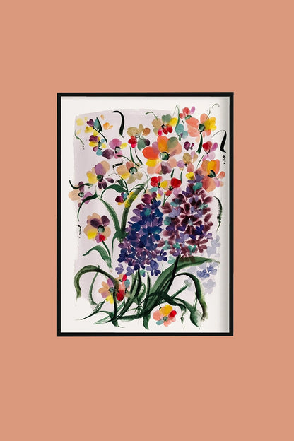 Black-framed purple hyacinth and mixed floral print on a peach wall.