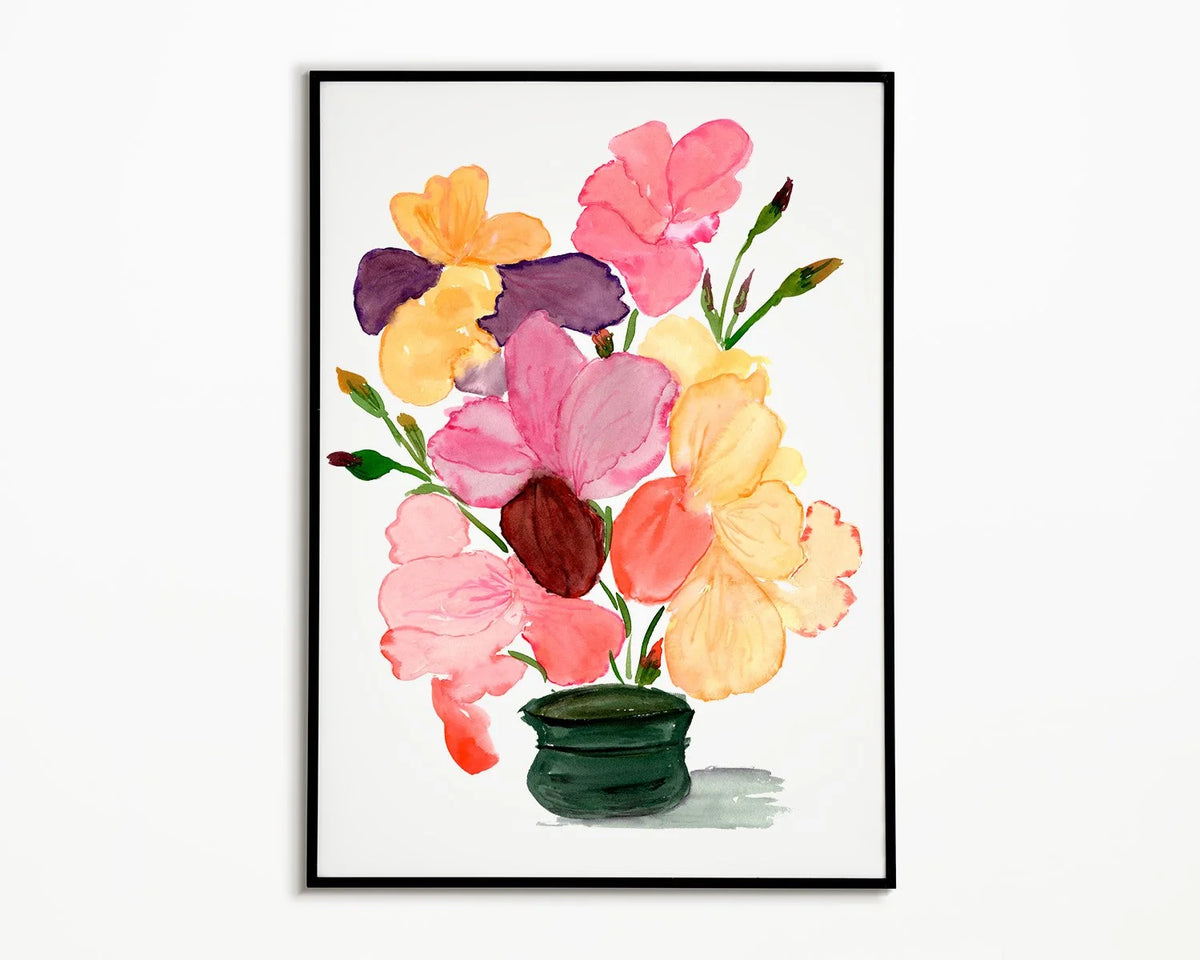 Black-framed print of pink, yellow and purple irises in a dark green vase.