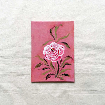 A small floral original painting on textured background featuring a pink and white rose with green leaves on a pink.