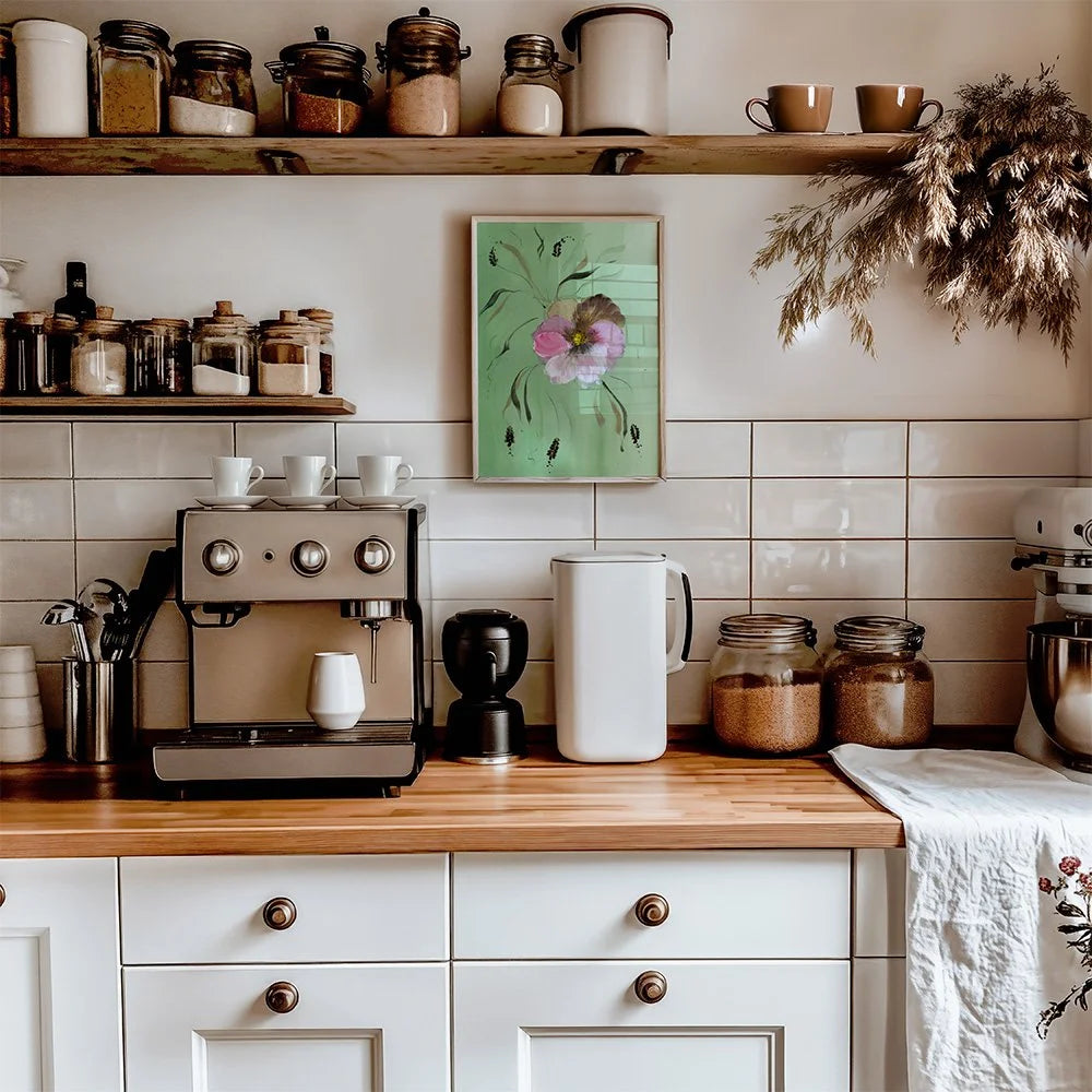 Pink pansy print on green above a kitchen counter with an espresso machine.