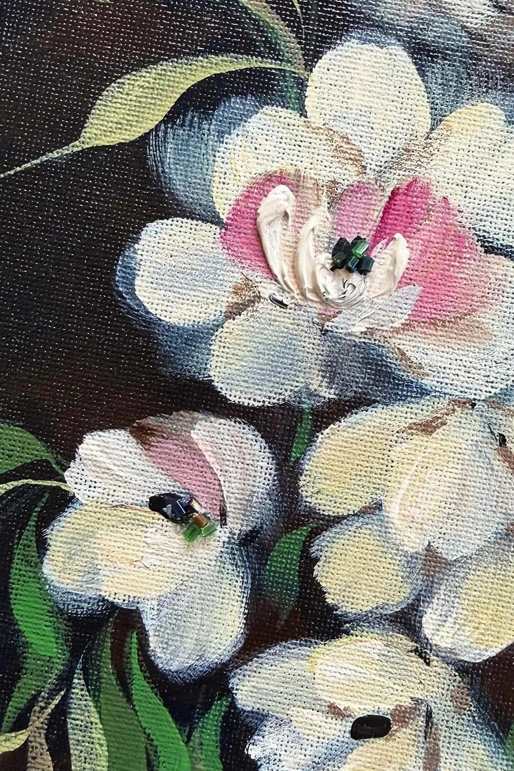 Close-up of a textured oil painting depicting white and cream magnolia flowers with pink centers and green leaves against a dark background.