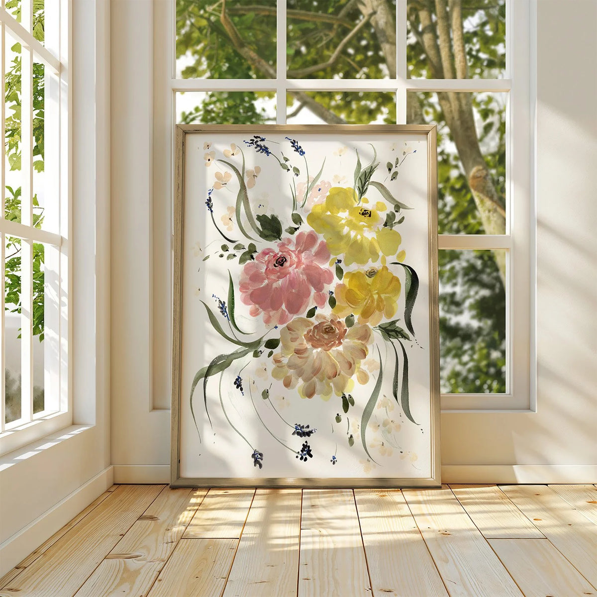 Framed pink and yellow ranunculus print leaning against a sunlit window.
