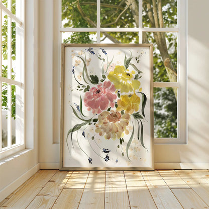 Framed pink and yellow ranunculus print leaning against a sunlit window.