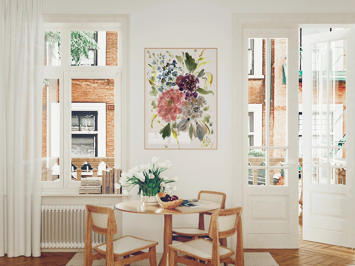 Pink, purple and blue floral print above a round dining table between two windows.
