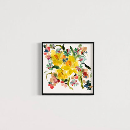 Square yellow narcissus print in a black frame on a pale wall.