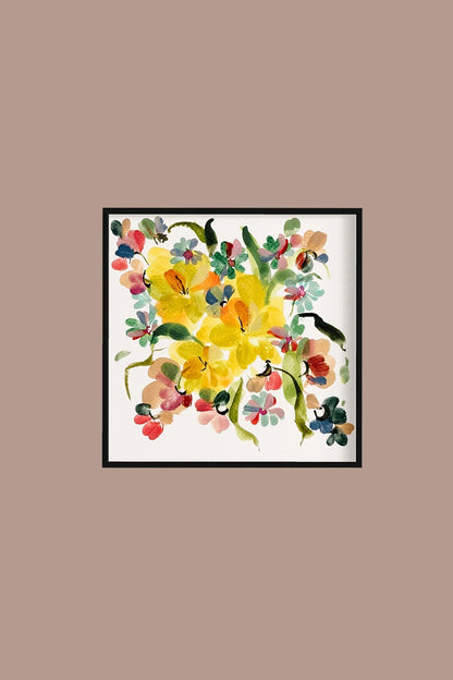 Square yellow narcissus print in a black frame on a warm taupe wall.