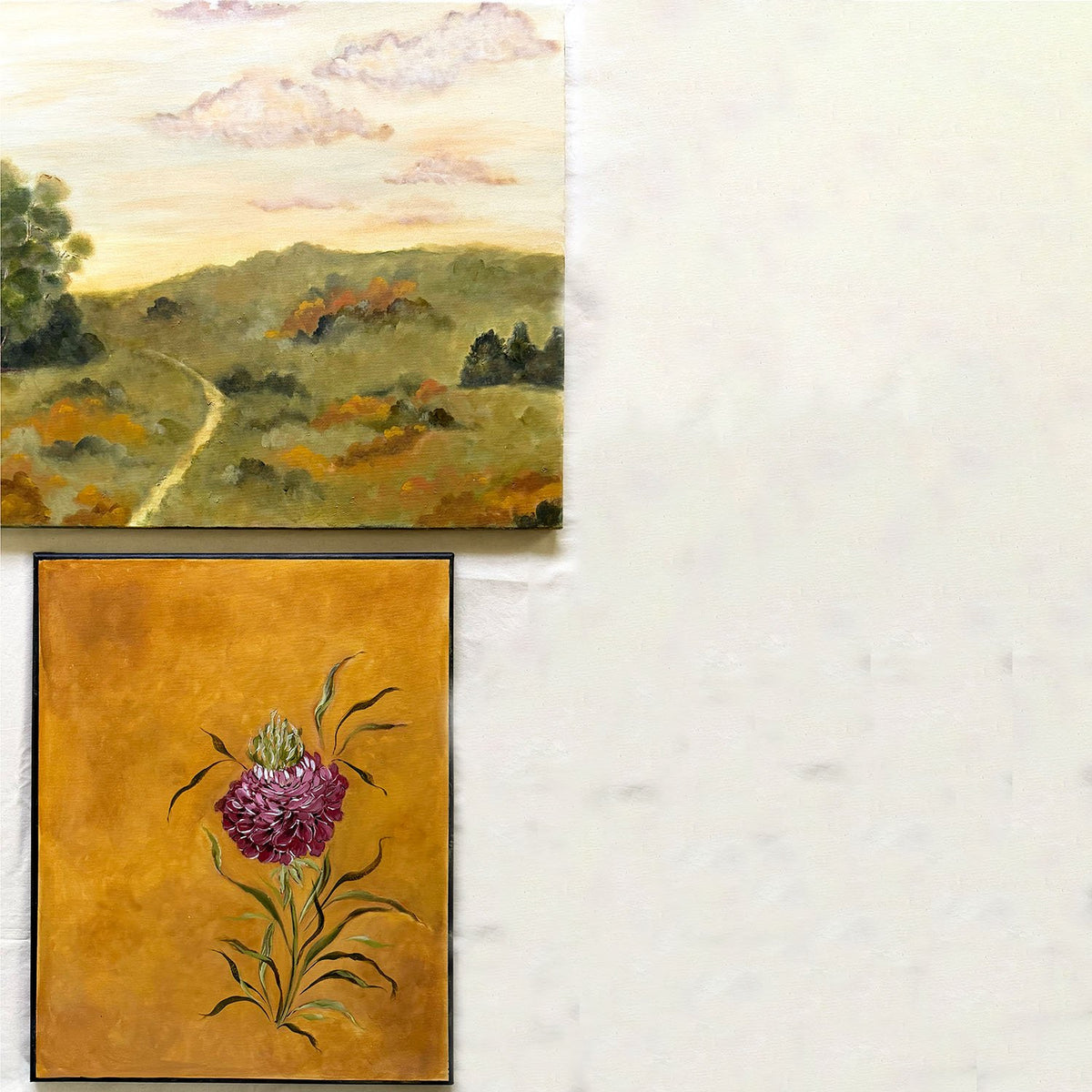 Two original artwork by Ramya RajivThe top print shows a pastoral landscape with rolling green hills, a winding path, and soft pinkish clouds in a warm sky.