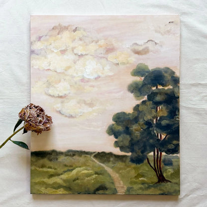 An oil painting by Ramya Rajiv of a landscape with a winding path through green fields under a cloudy sky