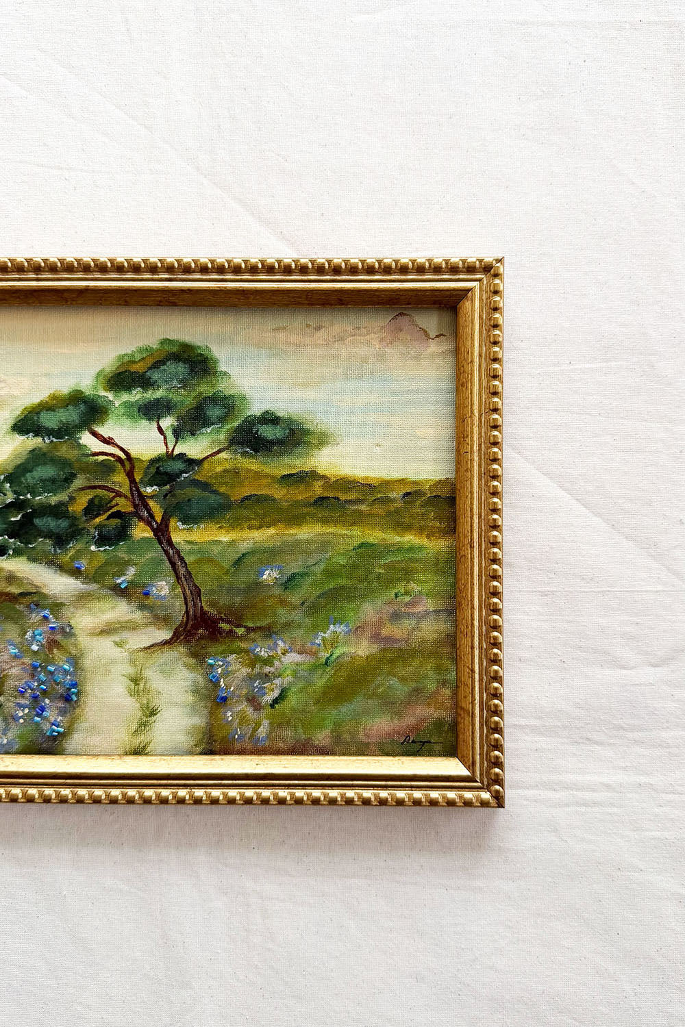 Close up of a framed original pastoral landscape painting