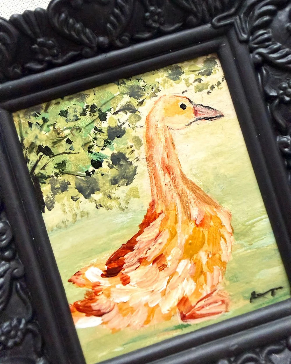 A framed hand-painted original painting of a goose, featuring a textured black ornate frame.