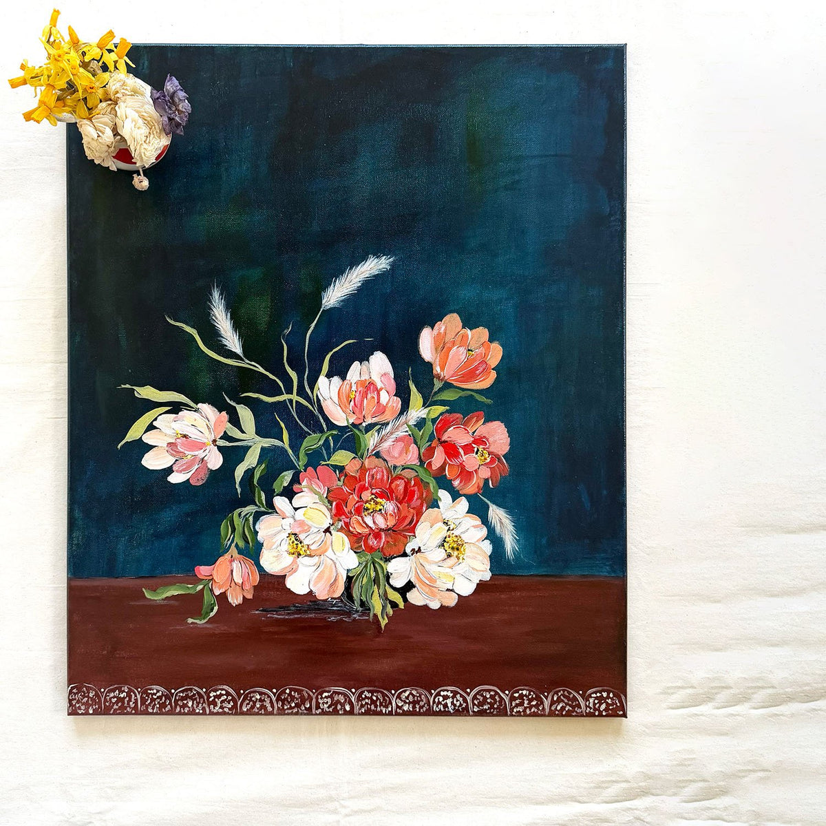 A original 20x24 inches canvas painting featuring a still life floral arrangement with red, pink, and white flowers on a dark blue background and brown base