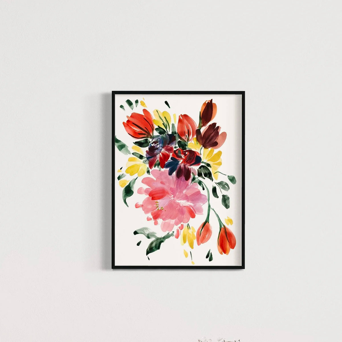 Pink peony and red-orange tulip print in a black frame on a pale wall.