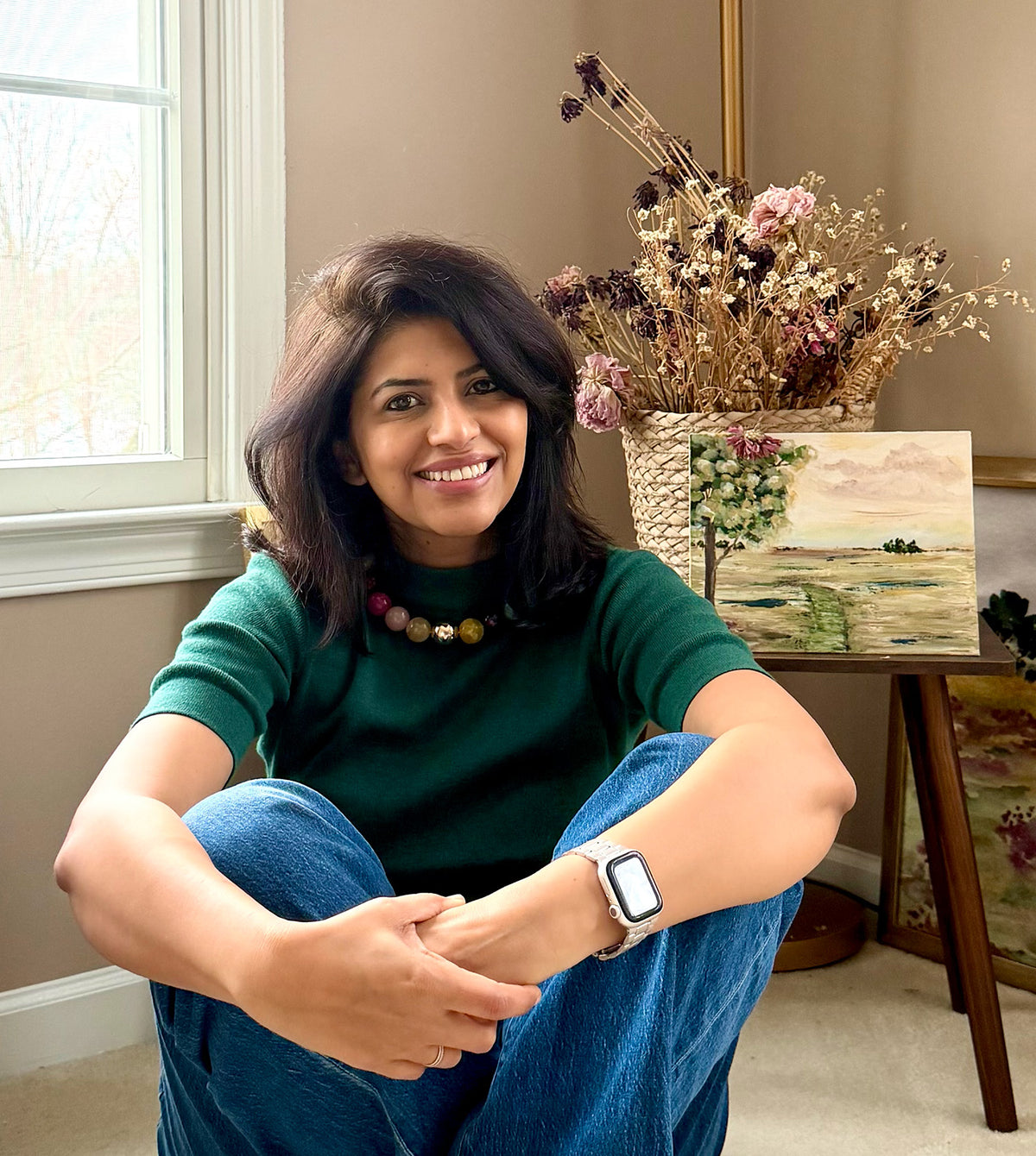 Studio shot of artist Ramya Rajiv. Ramya specializes in old world florals and landscape that act as an anchor for calm in our daily lives. She is New Jersey Artist