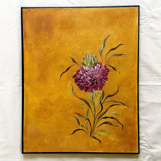 A framed original painting of a single purple-pink ranunculus with green leaves on a textured golden-yellow background