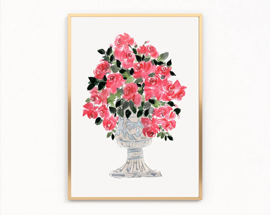 Gold-framed print of pink roses and green leaves arranged in a decorative pedestal vase.