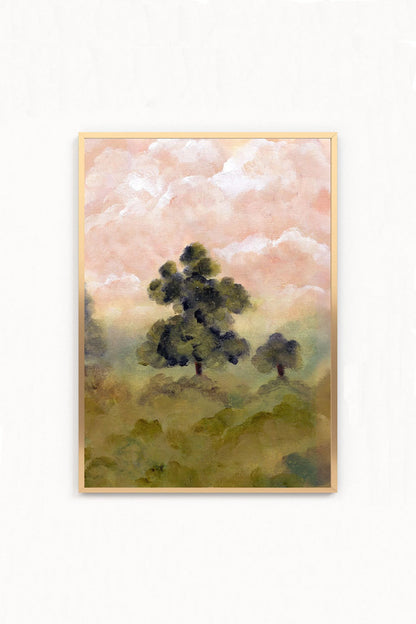 A framed landscape art print featuring dark green trees under a soft pink and white sky,