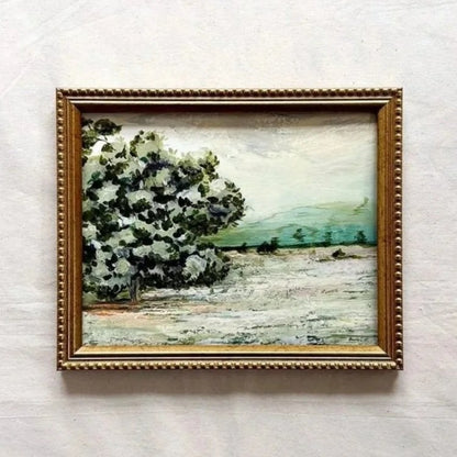 A framed landscape original painting featuring a prominent white and green tree on the left, set in a textured gold frame 