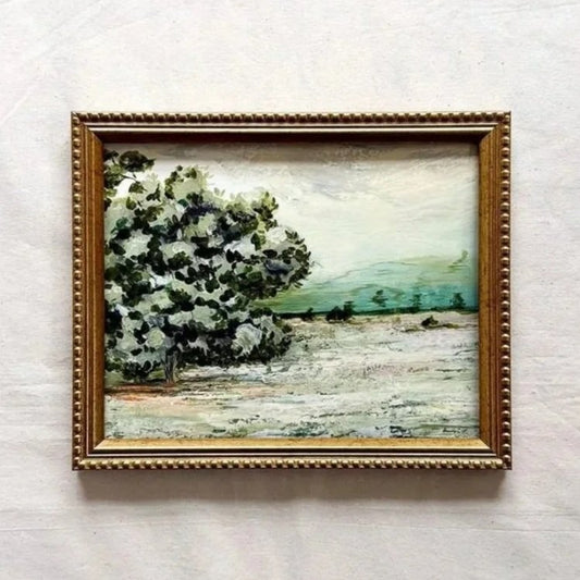 A framed landscape original painting featuring a prominent white and green tree on the left, set in a textured gold frame 