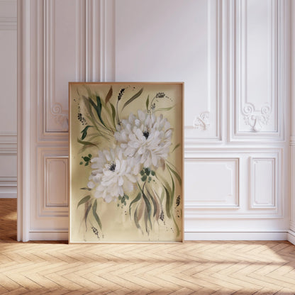 Large white dahlia print in a light frame leaning against ornate white wall molding.