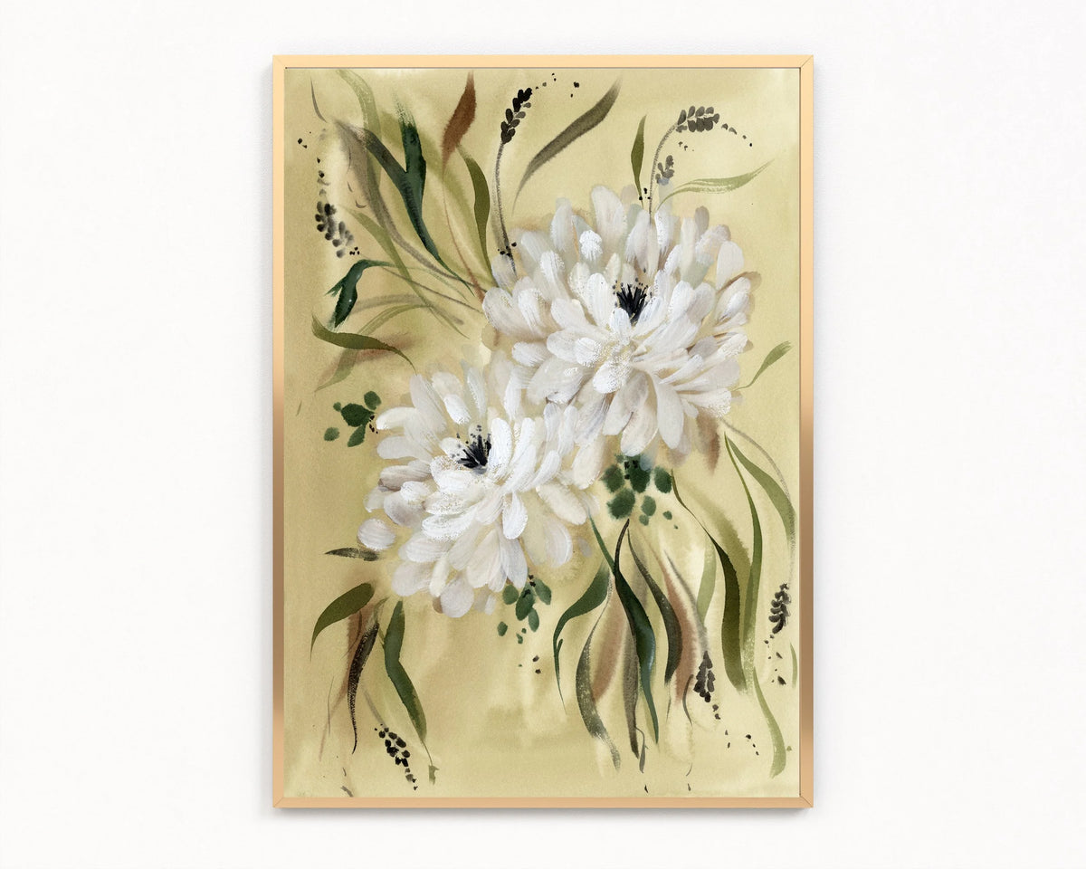 Gold-framed print of two white dahlias with flowing green leaves on a warm yellow-green background.