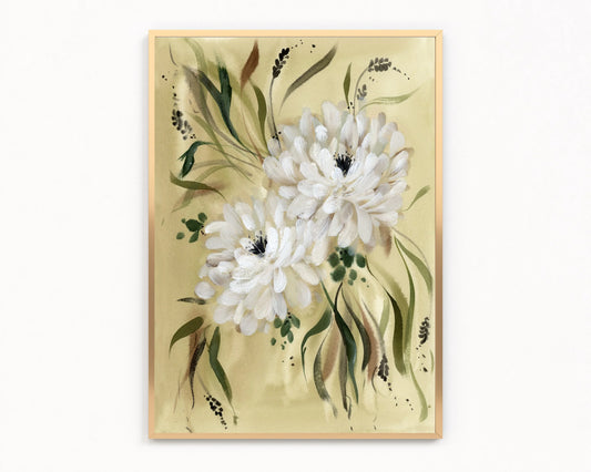 Gold-framed print of two white dahlias with flowing green leaves on a warm yellow-green background.