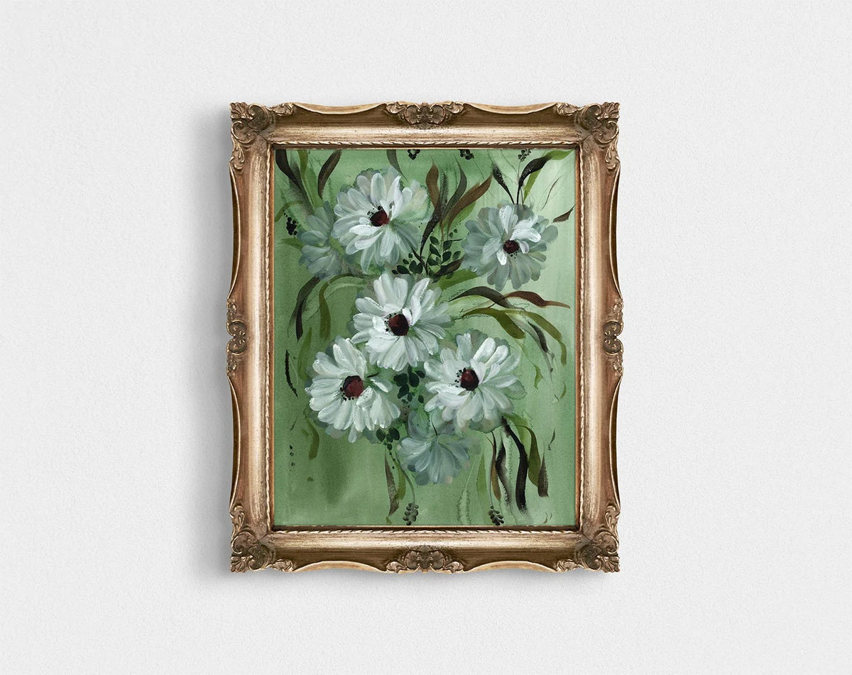 White daisy print on green in an ornate gold frame.