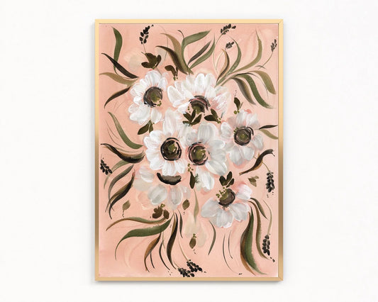 Gold-framed print of white Japanese anemones with dark centers and green leaves on peach.