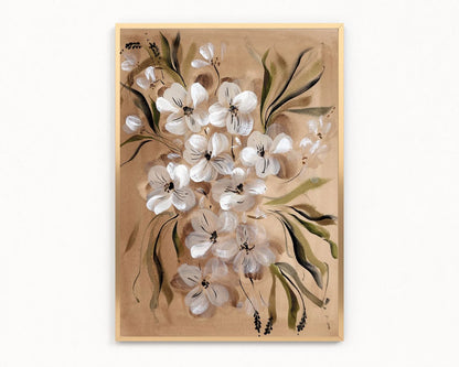 A framed botanical art print featuring white flowers with green leaves on a warm beige background, enclosed in a light wood frame and shown against a plain white wall.
