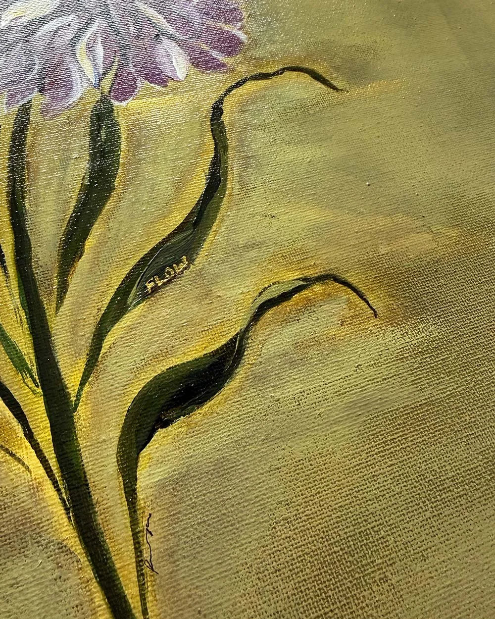 Close-up of a painted floral scene showing green leaves and part of a purple-and-white flower on a textured gold background.