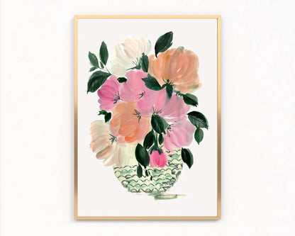 Gold-framed print of pink, peach and cream peonies in a patterned green vase.