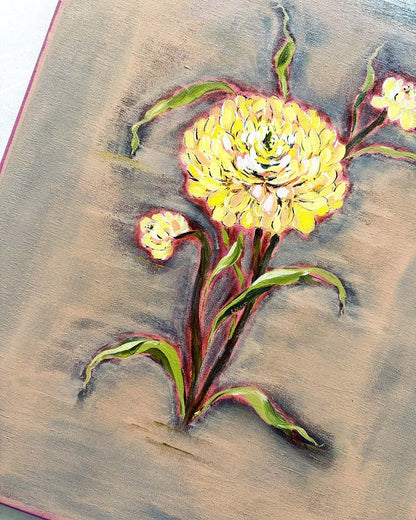 A close-up of a textured painting depicting a yellow flower with green leaves on a brown and gray background.